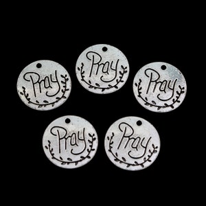 May include: Five silver-toned metal charms with the word "Pray" inscribed on each charm. Each charm has a small loop at the top for attaching to a necklace or bracelet.