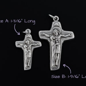 May include: Two silver crucifixes with the image of Jesus Christ and Mary. The larger crucifix is 1-9/16 inches long and the smaller crucifix is 1-3/16 inches long.