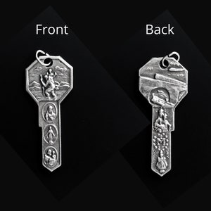 May include: Silver key-shaped pendant with a religious design. The front features a depiction of Saint Christopher carrying a child. The back features a depiction of a bridge and the words "Roma" and "Italy".