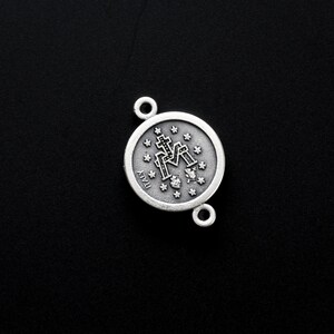 May include: Silver charm featuring a detailed image of the Virgin Mary with the words "ITALY" on the reverse.