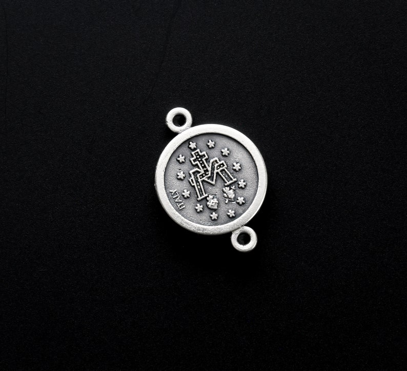 May include: Silver charm featuring a detailed image of the Virgin Mary with the words "ITALY" on the reverse.