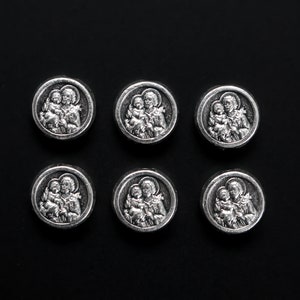 May include: Six silver-toned metal medallions with images of a mother and child. Each medallion features a different image of the mother and child.