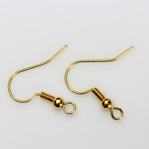 May include: Two gold-toned earring hooks with a spring-loaded closure. The hooks are made of metal and have a smooth finish.