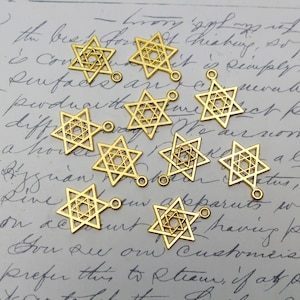 May include: Ten gold-colored metal charms in the shape of a six-pointed star. Each charm has a loop at the top for attaching to a necklace, bracelet, or other jewelry.