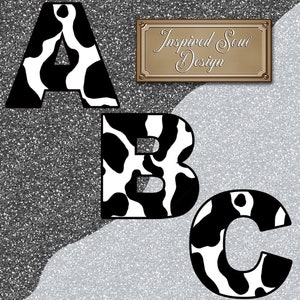 May include: Black and white cow print letters A, B, and C. The letters are on a silver glitter background. The text "Inspired Soul Design" is on a gold rectangle.