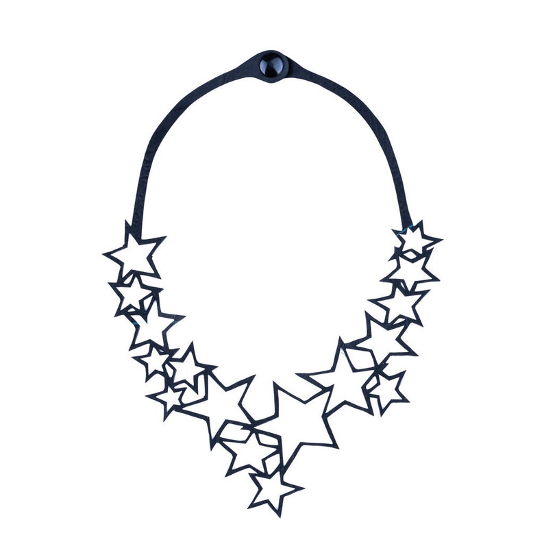 May include: A black leather necklace with a star-shaped cutout design. The necklace is made of a single piece of leather that is cut into a series of stars.