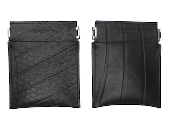 May include: Two black wallets made from recycled inner tubes. The wallets have a zipper closure and the brand name "RECYCLE" is printed on the front.