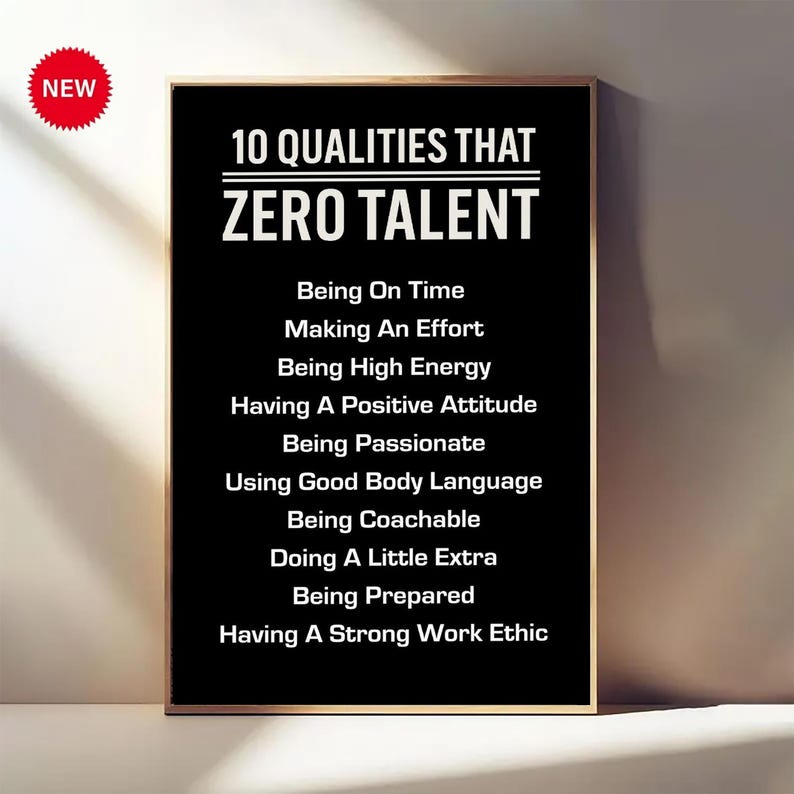 May include: A framed black and white print with the text "10 QUALITIES THAT ZERO TALENT" and a list of ten qualities. A red "NEW" sticker is in the upper left corner. The frame is gold.