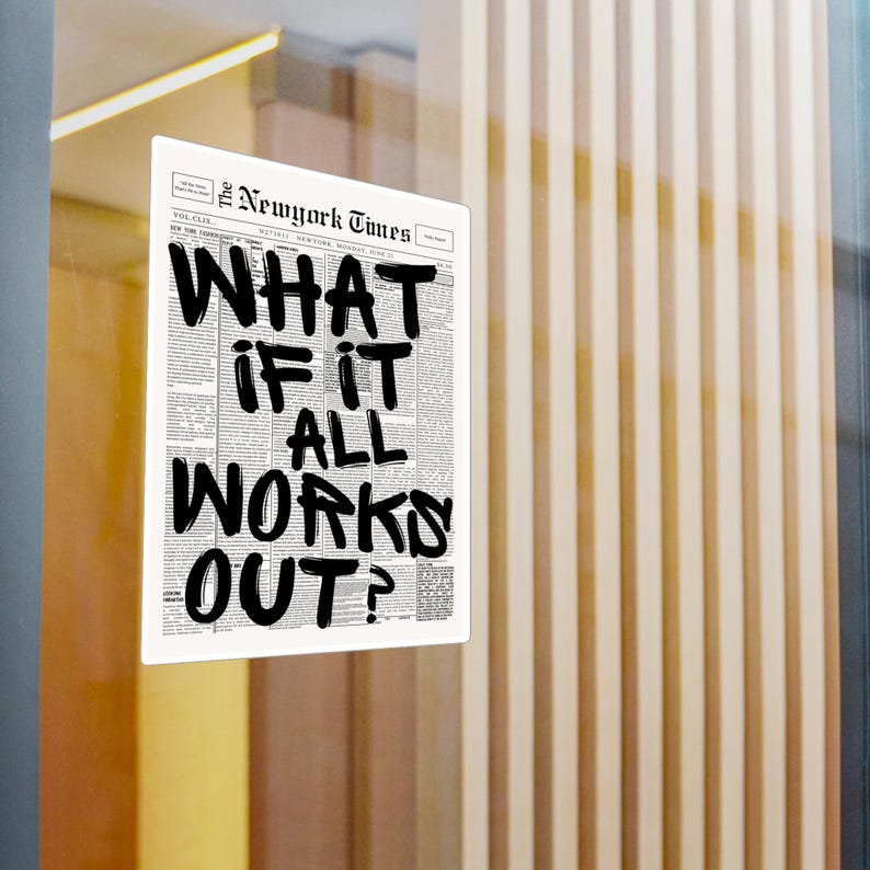 May include: A framed print of a New York Times newspaper page with the headline "WHAT IF IT ALL WORKS OUT?" in bold, black lettering. The print is displayed against a backdrop of vertical wooden panels.
