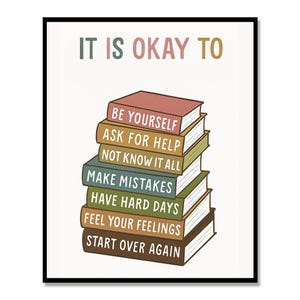 May include: A framed print with the words "IT IS OKAY TO" at the top, above a stack of books. Each book spine has a different phrase, including "BE YOURSELF" and "START OVER AGAIN". The text is in various colors.