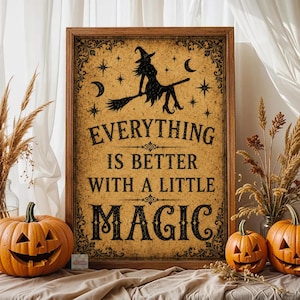 May include: A rectangular framed wall sign with a distressed tan background and black text that reads, Everything is better with a little magic. The design features a silhouette of a witch on a broomstick, stars, and crescent moons.