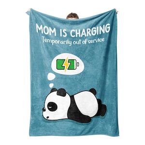 May include: A blue fleece blanket with the text "MOM IS CHARGING Temporarily out of service" and a cartoon panda sleeping with a thought bubble above its head that says "charging".