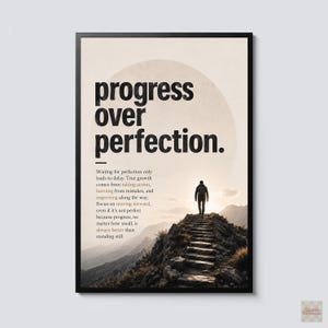 May include: A framed wall art print featuring the black text "progress OVER perfection." and a paragraph of smaller text below it. The image shows a person walking up a stone staircase on a mountain path toward a bright, hazy horizon.