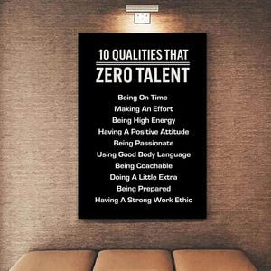 May include: A black rectangular wall art piece with white text. The text reads "10 QUALITIES THAT ZERO TALENT" followed by a list of ten qualities. The artwork is mounted on a textured wall.