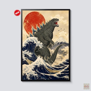 May include: A framed wall art print featuring a dark gray Godzilla creature standing amidst large, stylized blue ocean waves. A large red sun sits in the background above a snow-capped mountain peak. The print includes a small red starburst icon labeled NEW.