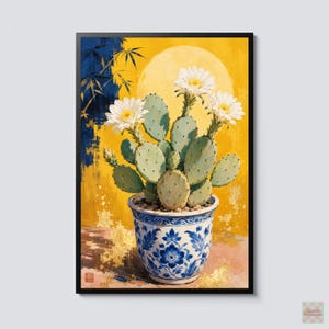 May include: A framed painting of a prickly pear cactus with three white flowers in a blue and white floral patterned ceramic pot. The background features a large yellow moon, dark blue bamboo stalks, and gold leaf accents on a textured surface.
