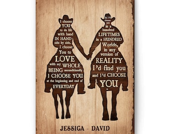 May include: A rustic wooden sign with a silhouette of two people riding horses. The sign features a romantic message about love and choosing each other in every reality. The names Jessica and David are printed at the bottom of the sign.