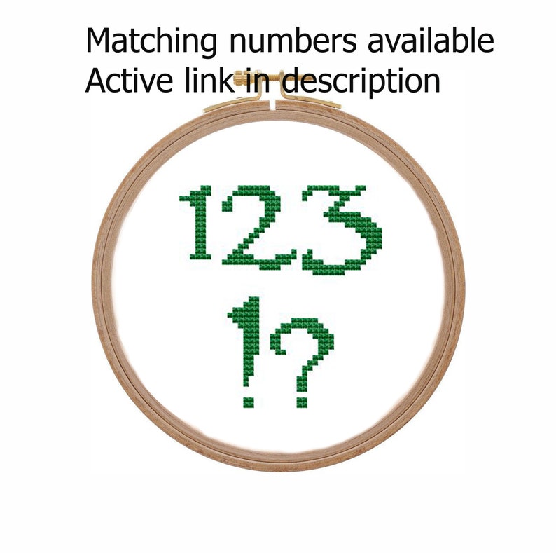 May include: Green cross-stitch embroidery of the numbers 123 and 1? in a wooden embroidery hoop.