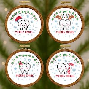 Könnte beinhalten: Vier runde, hölzerne Stickrahmen mit Kreuzstichmustern. Jeder zeigt einen lächelnden Zahn mit festlichen Weihnachtsdekorationen, umgeben von Schneeflocken und dem Text "MERRY XMAS".