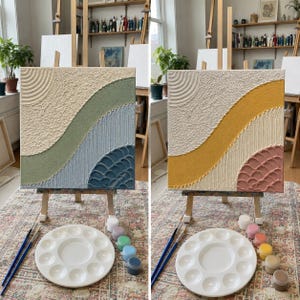 May include: A square textured wall art canvas featuring raised plaster patterns with concentric circles, wavy bands, and scalloped details. The left canvas displays sage green and blue tones, while the right canvas features yellow and dusty pink hues.