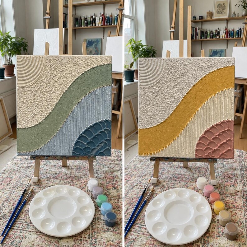 May include: A square textured wall art canvas featuring raised plaster patterns with concentric circles, wavy bands, and scalloped details. The left canvas displays sage green and blue tones, while the right canvas features yellow and dusty pink hues.
