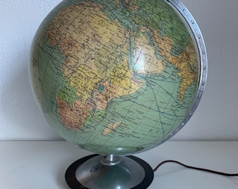 May include: A vintage green globe with a black base and a silver meridian. The globe features a detailed map of the world with continents and oceans labeled in French.