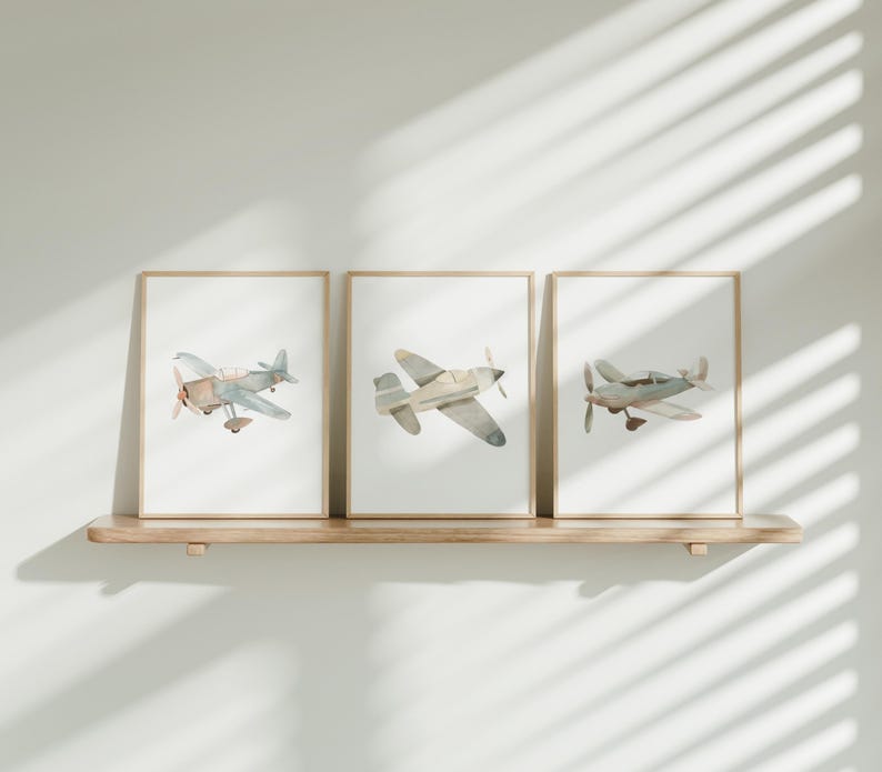three framed photos of airplanes hanging on a wall