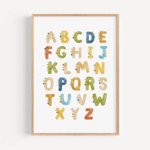 a print of the alphabet in a wooden frame