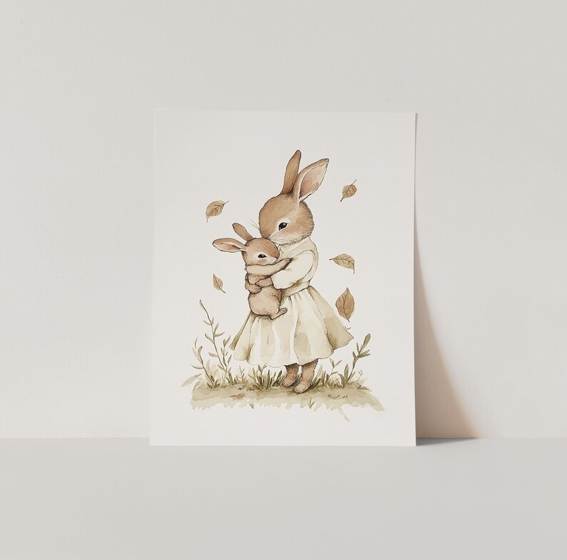 a card with a picture of a rabbit holding a baby