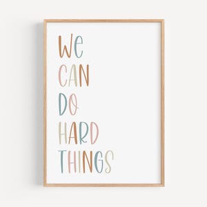 a framed poster with the words we can do hard things