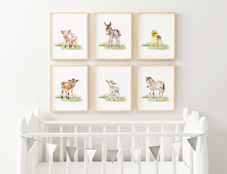 May include: Set of six watercolor prints featuring baby farm animals. The prints depict a pig, donkey, chick, calf, goat, and foal, each standing on a green grassy field.