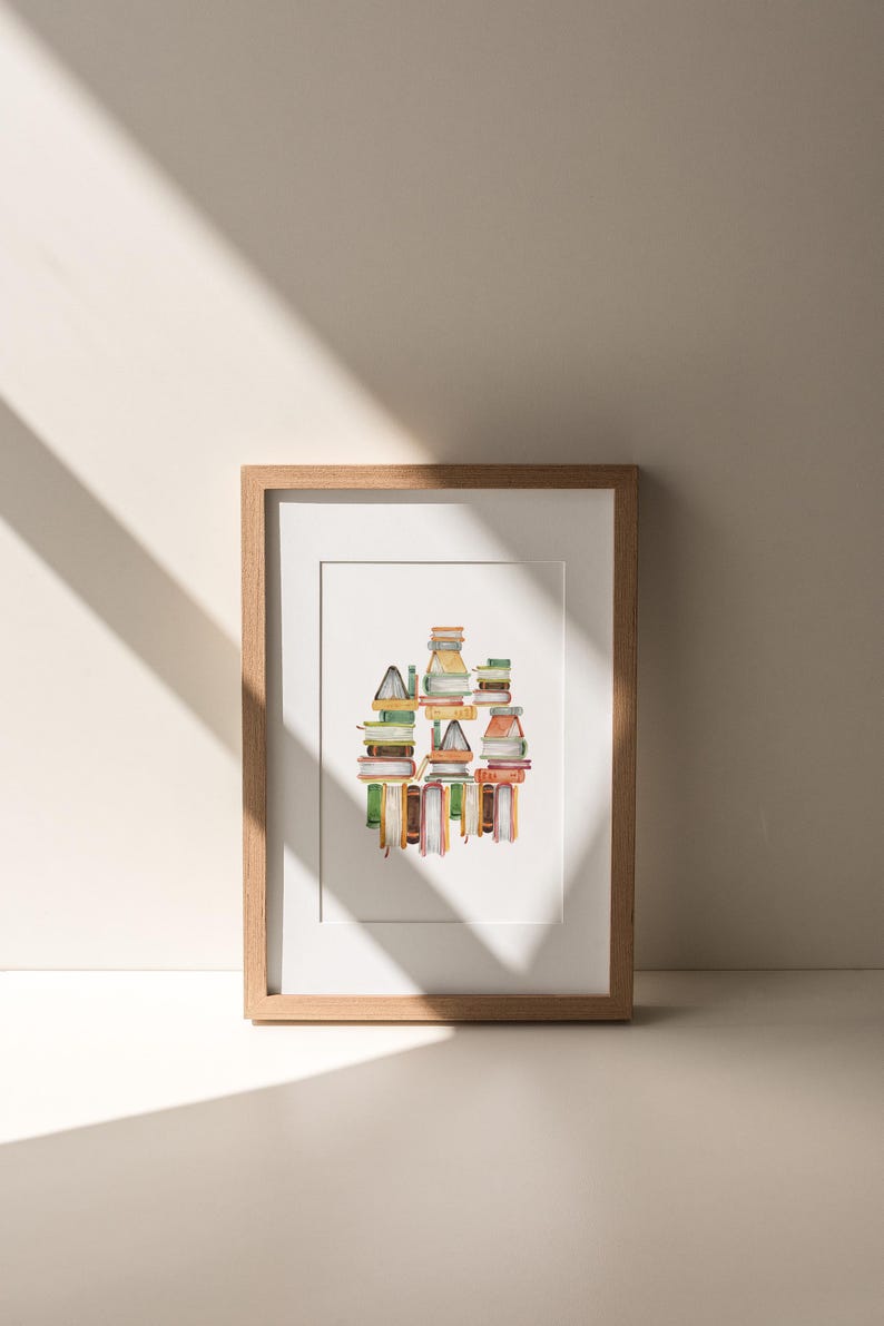 A framed artwork depicting a colorful abstract design is displayed on a white wall, with sunlight casting shadows on the wall.