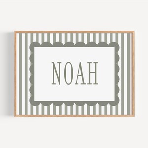 A framed image with a white background and a border of gray stripes. The word "NOAH" is prominently displayed in the center of the frame.