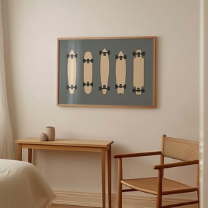 a bedroom with a bed, a wooden table, and a chair. Above the table, there is a framed artwork depicting five skateboards in a row.