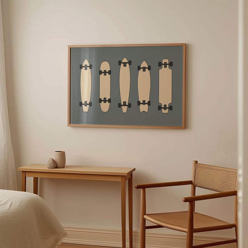 a bedroom with a bed, a wooden table, and a chair. Above the table, there is a framed artwork depicting five skateboards in a row.