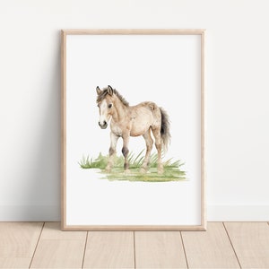 May include: A watercolor painting of a brown and white foal standing in a field of green grass.
