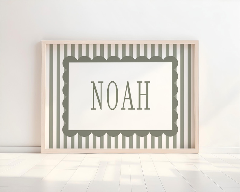 A framed picture with the word "NOAH" displayed on it, set against a background of vertical stripes.