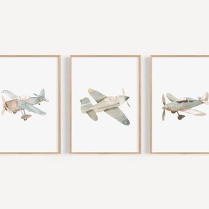 a set of three framed pictures of airplanes