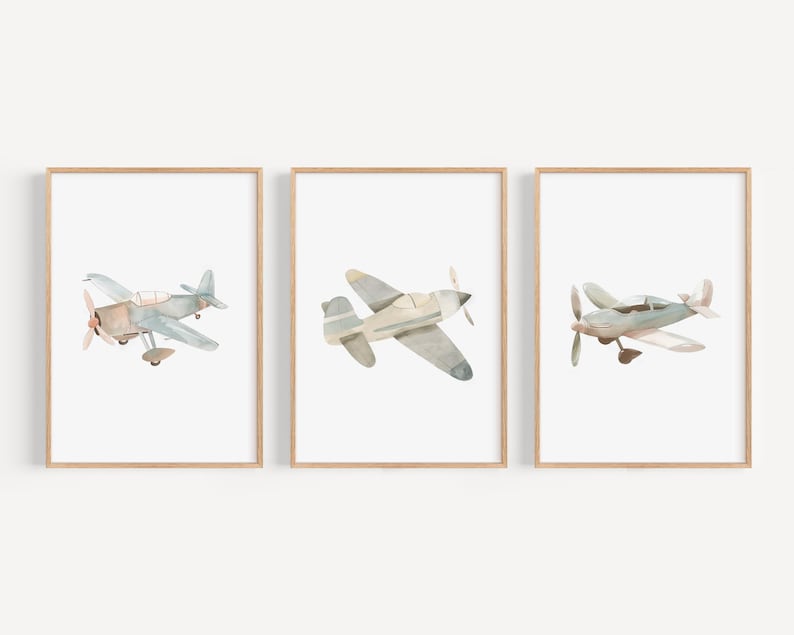 a set of three framed pictures of airplanes