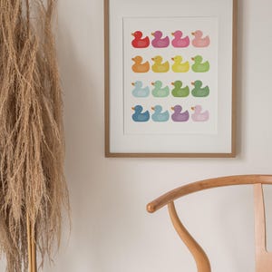 a picture hanging on a wall next to a chair