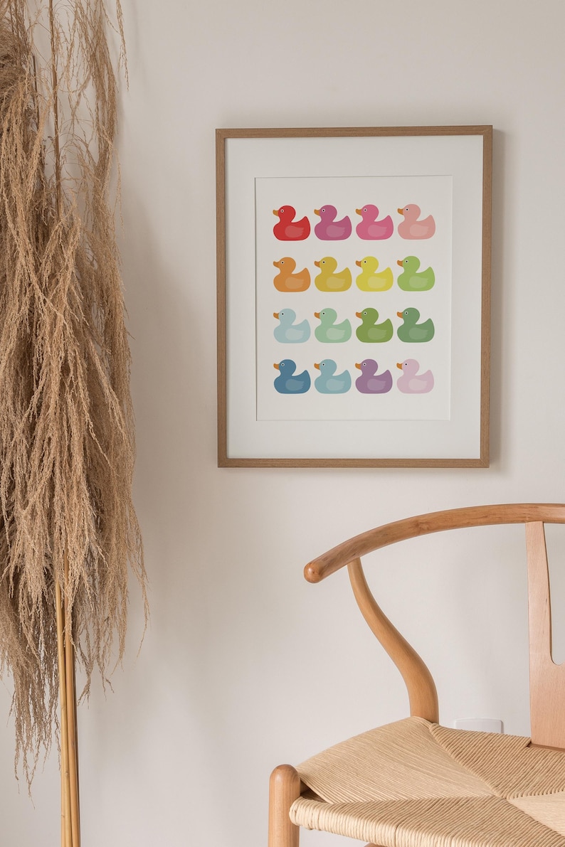 a picture hanging on a wall next to a chair