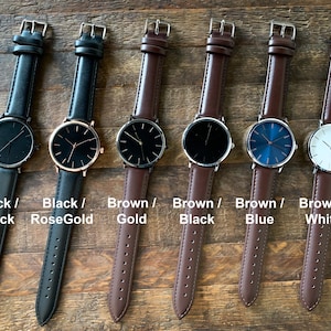 May include: Six minimalist watches with leather straps are displayed. The watches have black, rose gold, and gold cases, with black, blue, and white faces. The text on the image reads "Black / Black", "Black / RoseGold", "Brown / Gold", "Brown / Black", "Brown / Blue", and "Brown / White".