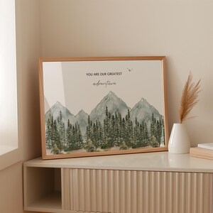 a picture frame sitting on a shelf next to a vase