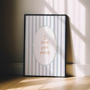 a picture frame sitting on a wooden floor next to a wall