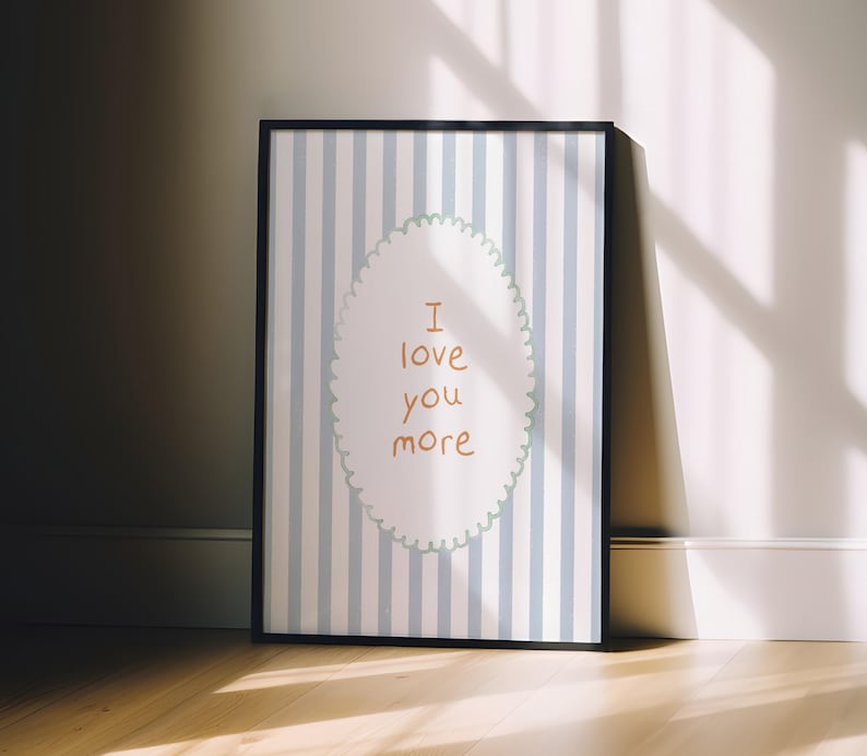 a picture frame sitting on a wooden floor next to a wall