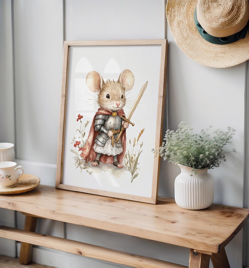 a mouse dressed in a knight's armor, holding a sword and standing in a grassy field with flowers. The mouse is the central focus of the image, which is framed and displayed on a wooden shelf or table.