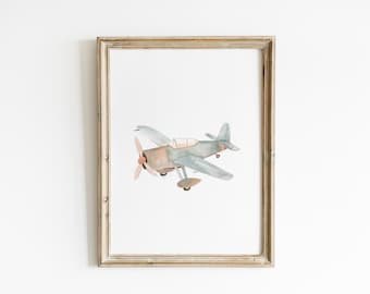 May include: Watercolor illustration of a vintage airplane in a distressed wooden frame. The plane features a light blue and brown color scheme with a propeller and wings. The artwork is set against a white background.
