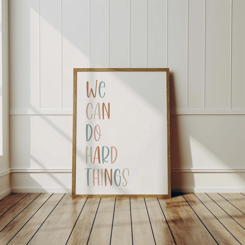 a picture frame sitting on a wooden floor next to a wall
