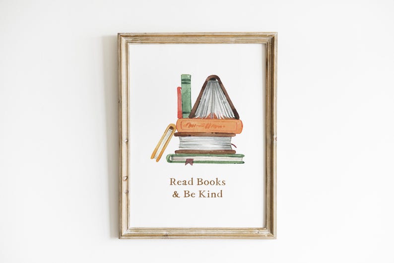 The image is a framed print with a watercolor illustration of a stack of books, accompanied by the text "Read Books & Be Kind" below the illustration.