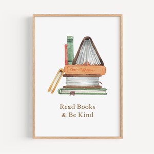 The image is a framed print with a watercolor illustration of a stack of books. The text below the illustration reads "Read Books & Be Kind".